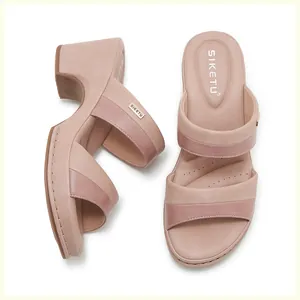 Macro view of women's wedge sandals with two-tone pink straps and soft padded footbed