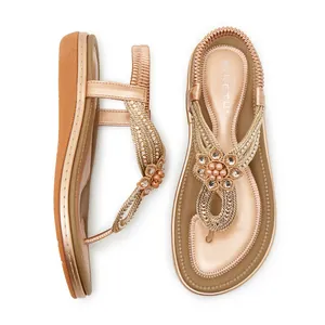 Close-up of bohemian wedge sandals with intricate rhinestone and pearl flower details