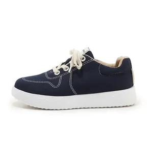 Detailed side view of navy canvas sneaker featuring textured thick white sole and contrast stitching