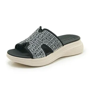 Detail van zilveren H-band platformsandalen met kristallen en een dikke beige zool