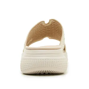 Achteraanzicht van beige gebreide slippers met sleehak en antislipgolfstructuur op de zool