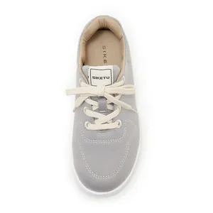 Top-down view of gray lightweight non-slip casual sneakers with white laces