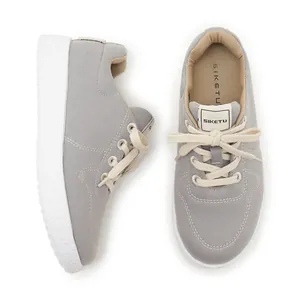 Close-up of lightweight grey canvas sneakers with anti-slip white thick soles