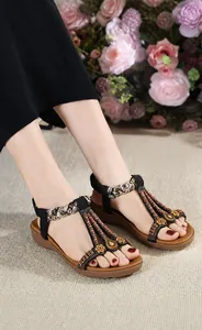 Detail of bohemian summer sandals with beaded rhinestones and satin woven textures