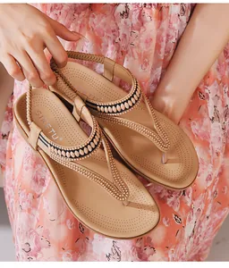 Details der Zehentrenner-Sandalen mit Perlenbestatz, Keilabsatz und Bohemian-Sommerstil