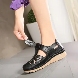 Women's black wedge sandals with hollow leather upper and adjustable velcro closure