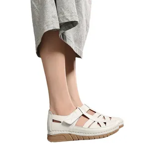 Women's hollowed wedge sandals with stitching detail and velcro straps in off-white