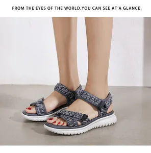 Detail of grey woven strap sandals with wave-pattern platform sole and velcro strap