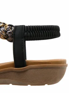 Close-up of women sandals featuring elastic heel strap and sparkling rhinestone detail
