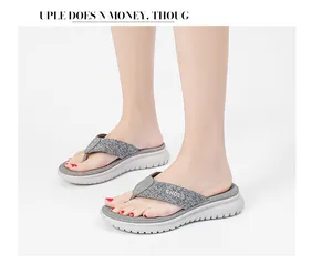 Detail view of grey knit flip flop straps with studs and thick platform sole