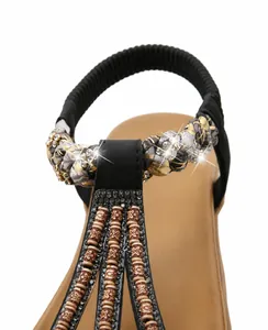 Detail of satin sandals with rhinestone embellishments and elastic ankle straps