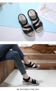 Detail view of black platform sandals with adjustable straps and soft cushioned sole