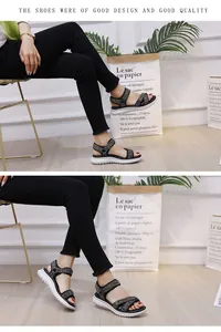 Close-up of women's platform sports sandals with grey woven straps and thick white soles