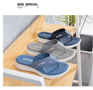 Close-up of stylish wedge flip flops in blue and grey with metallic dot knit straps