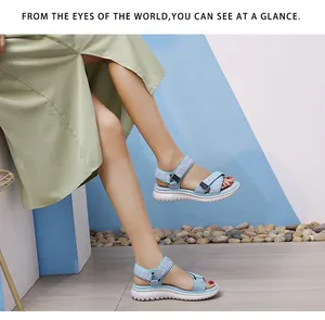Detail of light blue floral sport sandals with thick platform sole and velcro strap