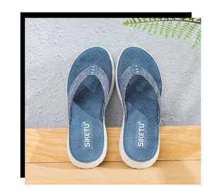 Close-up of blue denim flip-flops featuring metal rivets and thick anti-slip soles