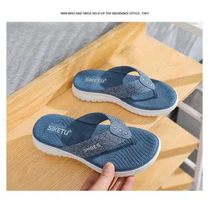Detail of navy platform flip flops featuring metal studs and thick white EVA outsole
