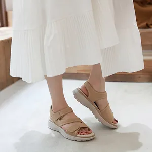Women's beige leather platform sports sandals with velcro straps and thick cushioned soles