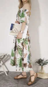 Ethnic style flat sandals with colorful beads and tassels paired with a floral dress