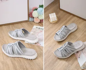 Macro detail of grey breathable mesh slide sandals with thick white anti-slip soles