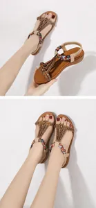 Detail of bohemian women's sandals featuring metal beads and sunflower floral appliques