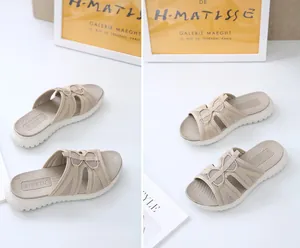 Close-up of beige woven straps and thick white platform sole on women's comfort slides