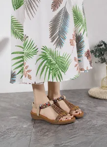 Detail of bohemian flat sandals featuring ethnic beadwork and elastic heel straps
