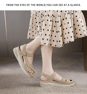 On-foot view of beige wedge sandals featuring thick soles and cross-strap velcro details