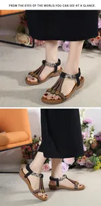 Detail of bohemian wedge sandals with black straps and intricate beadwork and sequins