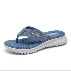 Women's platform flip-flops in navy blue with sequin straps and a thick white wedge sole