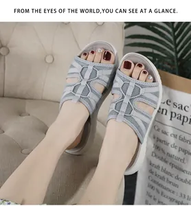 Close-up of women's grey mesh slide sandals with soft cushioned sole and woven strap detail