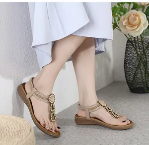 Close-up of bohemian flat sandals with sparkling beads and ethnic T-strap design