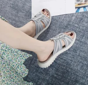 Top-down view of light grey platform sandals with breathable mesh cross straps on model feet