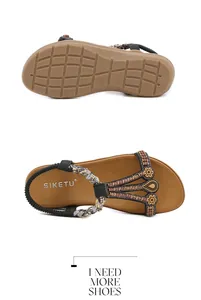 Detail view of Bohemian beaded sandals with metal flower accents and anti-slip rubber sole