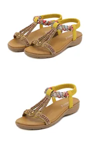 Detail of yellow Bohemian sandals with beaded T-straps and floral woven elastic heels