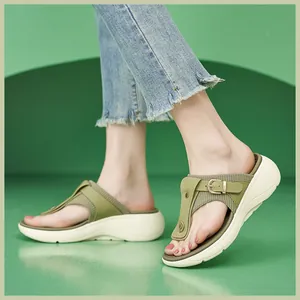 Side view of olive green platform slide sandals with metal buckle and chunky sole