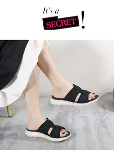 Low angle view of women's chunky platform sandals with black mesh straps and thick white sole