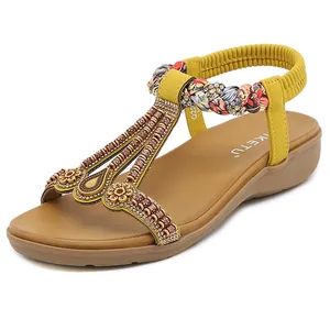 Bohemian style yellow flat sandals with ethnic beads, sequins and elastic back strap