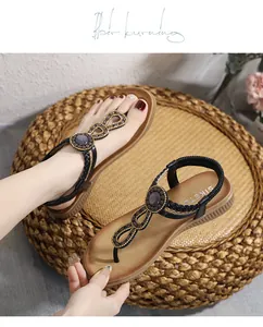 Close-up of bohemian flat sandals with intricate beadwork and elastic ankle straps