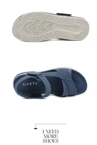 Detailed macro view showing non-slip wavy sole and navy velcro straps of ladies' sandals