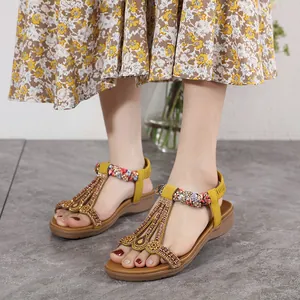 Yellow bohemian wedge sandals with beaded T-strap and colorful woven details for women