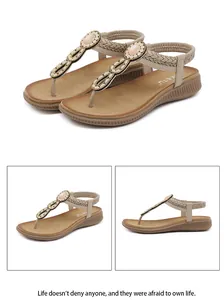 Detail of bohemian flat sandals featuring beaded T-strap design and elastic back strap