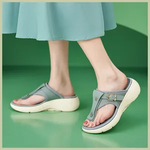 Detail view of platform flip-flop sandals with green strap and metallic buckle on model