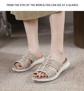 Close-up of khaki mesh women slippers with cross straps and white thick sports soles