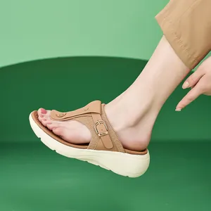 Brown leather thong platform sandals for women with buckle detail and wave-patterned thick sole