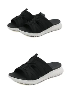 Detail view of black mesh athletic sandals featuring a thick white cushioned sole