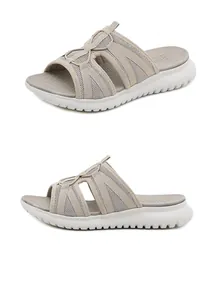 Close-up of beige athletic sandals featuring breathable mesh and thick sport soles