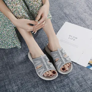 Women's grey mesh mule sandals with thick white sole shown on feet in casual setting
