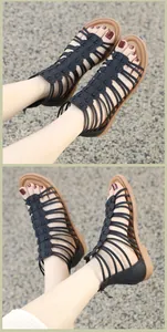 Macro detail of black multi-strap gladiator sandals with textured PU leather and rear zipper