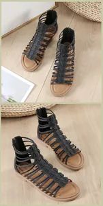 Macro detail of black Roman cage sandals with snakeskin pattern and rear zip closure